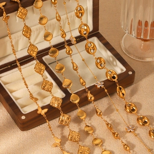 18K gold-plated stainless steel necklaces with shell, butterfly, and drop charms in a box