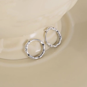 Minimalist silver bamboo knot hoop earrings for women with polished metallic texture