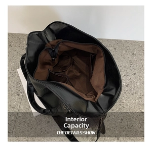 Top view showing spacious interior of black canvas tote with zipper pocket