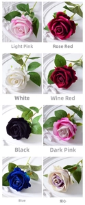 Detail view of artificial velvet roses in eight colors on white decorative plates