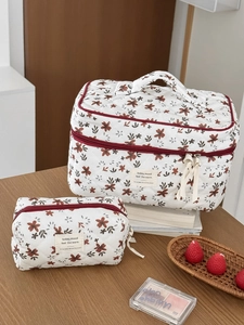Quilted corduroy floral makeup bag set with top handle and red ribbon zipper detail