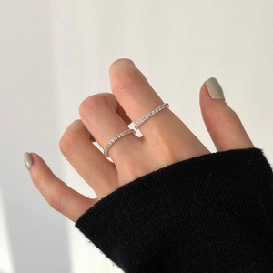Close-up of minimalist S925 sterling silver thin ring with sparkling zircon stones