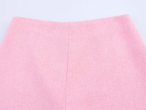 Nahaufnahme der rosa Tweed-Stoffstruktur und Nähte am Rockbund für Damenbekleidung