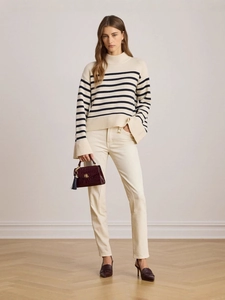 Women's striped knit sweater with high neck and wide-leg trousers in a minimalist style