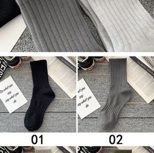 Detail of ribbed knit texture on black and grey mid-calf breathable cotton sport socks