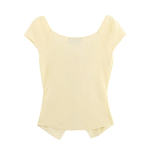 Detailed view of the yellow knit top featuring elegant ruched side details and irregular hem
