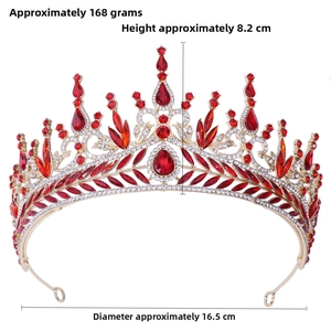 Detail of red crystal baroque bridal crown showing intricate patterns and golden texture
