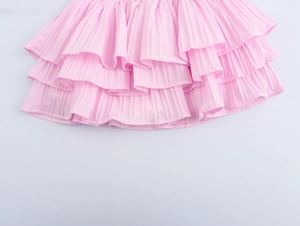 Close-up of pink layered ruffle skirt featuring soft pleated fabric and elastic waist