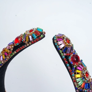 Close-up of baroque velvet headband with colorful rhinestones and gold metal details