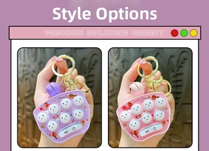 Handheld electronic whack-a-mole game keychain with colorful buttons and bell detail