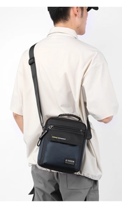 Men's large capacity nylon cross body bag shown on model with adjustable shoulder strap