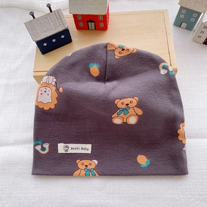 Detail of soft purple cotton baby beanie with cute cartoon bear and lion prints