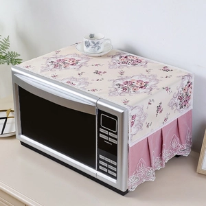 Close-up of linen microwave dust cover with floral patterns and pink lace pleat edging