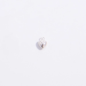 Close-up of a 3D polished S925 sterling silver heart-shaped charm with a metal ring