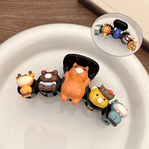Close-up of cute 3D cartoon animal hair claw clips with cat and bear figures