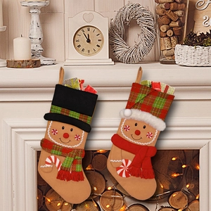 Christmas gingerbread man stocking gift bags hanging on a festive fireplace mantel set of 2