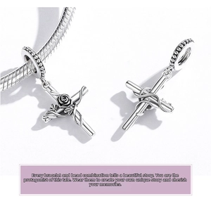 Macro view of S925 sterling silver vintage cross charm with rose vine details