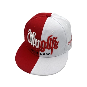 Gros plan sur la casquette bicolore rouge et blanche avec broderie Thug Life détaillée