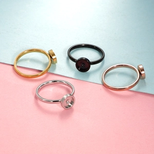 Flat lay of 17mm round DIY ring base settings in gold, black, silver, and rose gold
