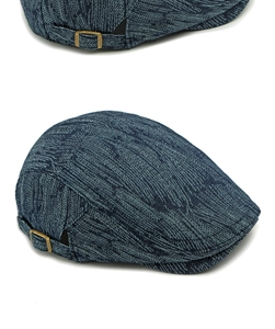 Macro detail of blue jacquard flat cap with brass buckle and textured denim fabric
