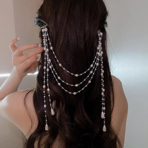 Detailed view of layered pearl fringe hair chain with silver chains and teardrop pearls