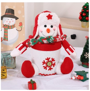 Close-up of snowman candy jar with red snowflake pattern and cozy holiday scarf
