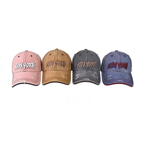 Close-up of four vintage baseball caps with NEW YORK embroidery and distressed details