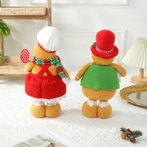 Pair of telescopic gingerbread man plush dolls in festive outfits for Christmas decor