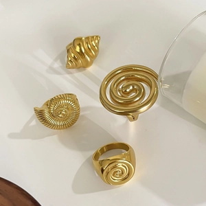 Set of four gold stainless steel rings featuring vintage shell and spiral hollow designs