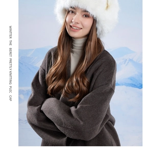Winter faux fur earmuff hat with cute animal ears shown against a snowy mountain background