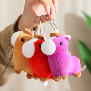 Close-up of three colorful plush pony keychains in brown, red, and purple colors