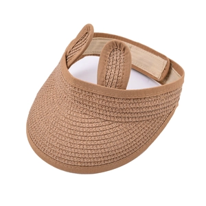 Detailed close-up of woven straw visor for kids with 3D bunny ears and adjustable strap