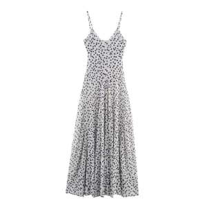 Elegant black and white polka dot maxi dress with thin spaghetti straps and V-neckline