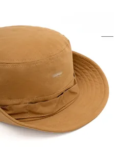 Close-up of a camel cotton outdoor sun hat with embroidered peak logo and wide brim