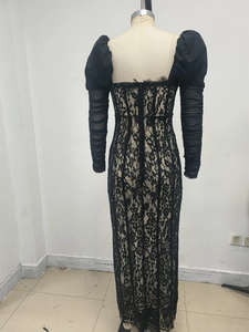 Detail of back view zipper and sheer lace floral patterns on the black evening gown