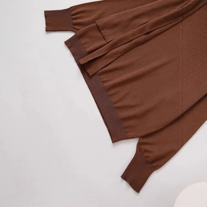 Fashionable oversized dark brown knit sweater with detailed ribbed cuffs and hemline
