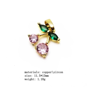 Macro shot of 11.5x13mm cherry pendant with pink and green zircon in copper setting