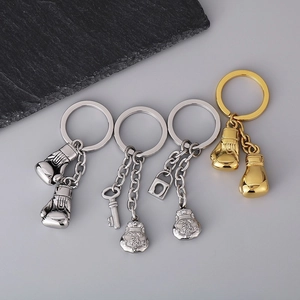 Polished stainless steel boxing glove and lucky pouch keychain in gold and silver