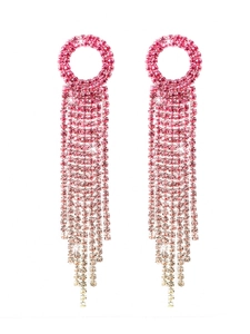 Macro view of luxury long tassel earrings with sparkling rhinestones in pink gradient