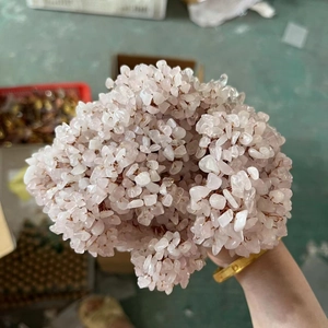 Macro shot of natural pink crystal chips bundled with metal wire for DIY money tree crafts