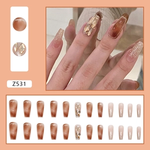 Long coffin press-on nails featuring a light coffee gradient and gold glitter accents