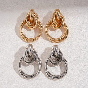 Metallic geometric knot earrings in gold and silver finish with multi-loop wrap design