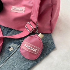Pink nylon crossbody bag with matching round coin pouch and FASHION logo tag