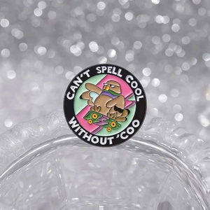 Round bird skateboard enamel badge with 'CAN'T SPELL COOL WITHOUT COO' quote