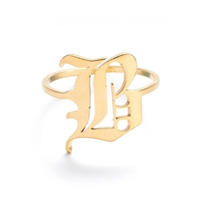 Macro shot of gold gothic letter B detail on vintage style stainless steel ring