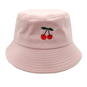 Close-up of pink bucket hat featuring delicate cherry embroidery and premium canvas texture