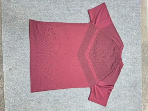 Detail view of the deep red sports t-shirt showing the V-shaped mesh back for ventilation