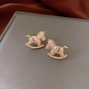 Cute cartoon rocking horse stud earrings with white zircon in premium gold finish