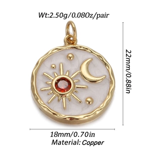 Macro view of gold copper celestial pendant with sun, moon and red gem 22x18mm detail