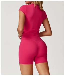 Rear view of hot pink yoga set showing slimming short sleeve top and lifted booty shorts